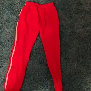 Red sweat pants with a white stripe on both side
